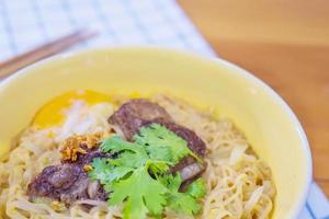 Instant noodle with pork and egg ready to be eaten - delicious instant food menu concept photo