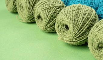 bright green yarn wool in a raw on bright background photo