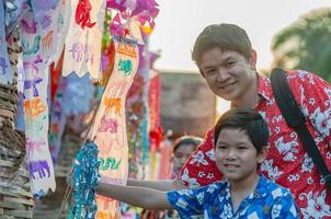 Thai family participate old traditional activity in a temple during Songkran festival in Chiang Mai Northern Thailand very famous event of Thailand photo