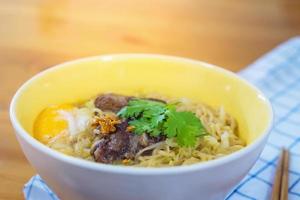 Instant noodle with pork and egg ready to be eaten - delicious instant food menu concept photo