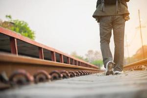 Travel man wait train at platform - people vacation lifestyle activities at train station transportation concept photo