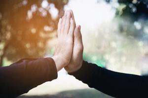 Man touching - holding hand together for success commitment work concept photo