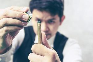 Snooker player standing waiting hold his cue stick and chalk prepare for his turn during competition match photo