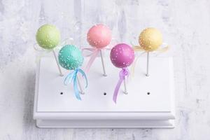 Colorful cake pops on a textured background photo