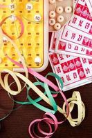 Bingo game with cards to play and serpentines. Vertical image viewed from above. photo