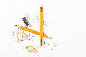 Pencil, metal sharpener and pencil shavings on white background. Horizontal image. photo