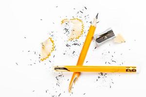 Pencil, metal sharpener and pencil shavings on white background. Horizontal image. photo