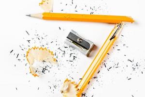 Pencil, metal sharpener and pencil shavings on white background. Horizontal image. photo