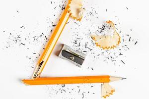 Pencil, metal sharpener and pencil shavings on white background. Horizontal image. photo