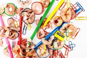 Color shavings pencils with pencil sharpener and clips viewed from above. Horizontal image. photo