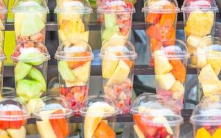 Fresh mix fruit in glasses prepare for blended menu - colorful fresh fruit background concept photo