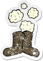 retro distressed sticker of a old boots cartoon vector