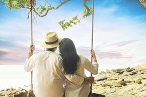 Couple relaxing on swing near to the beach - Rayong of Thailand photo