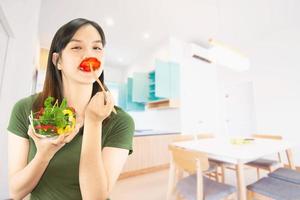 Happy lady holding kichen stuff over copy space background - people home made food preparation concept photo