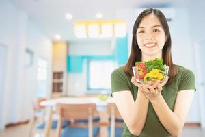 Happy lady holding kichen stuff over copy space background - people home made food preparation concept photo