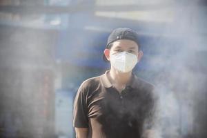 Man wearing mask protect fine dust in air pollution environment - people with protection equipment for air pollution concept photo