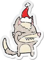 tired wolf distressed sticker cartoon of a wearing santa hat vector