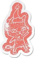 cartoon distressed sticker of a cat staring wearing santa hat vector