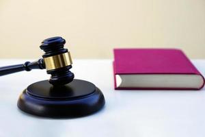 Close up of judge gavel, lawyer, law, justice with law book in background. photo