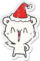 laughing polar bear distressed sticker cartoon of a wearing santa hat vector