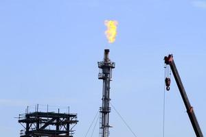 the refinery flare with cloud in background photo