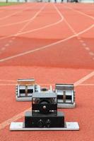 Athletics Starting Blocks on a red running track in a stadion photo