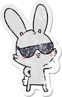 distressed sticker of a cute cartoon rabbit wearing sunglasses vector