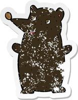 retro distressed sticker of a funny cartoon black bear vector