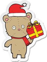 sticker of a cartoon christmas teddy bear with present
