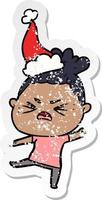 distressed sticker cartoon of a angry woman wearing santa hat vector