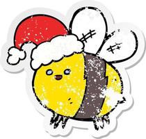 distressed sticker of a cute cartoon bee wearing christmas hat vector
