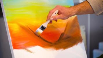 Painter using brush, oil painting. Painter's brush movements. He is preparing an oil painting. video