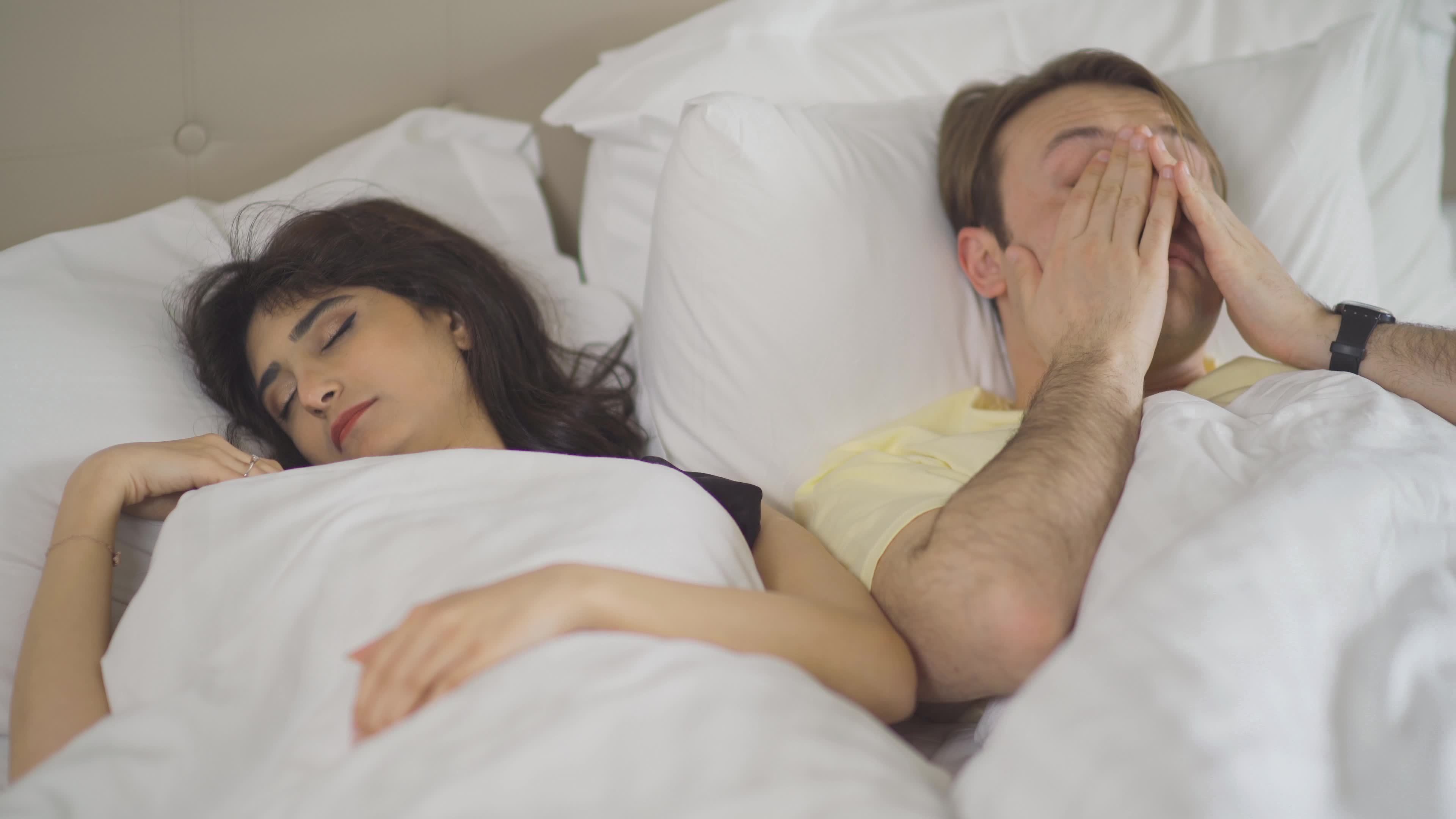 Man wakes up in the morning and kisses his wife