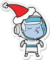 sticker cartoon of a confident astronaut wearing santa hat vector