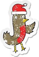 retro distressed sticker of a cartoon christmas robin wearing hat vector