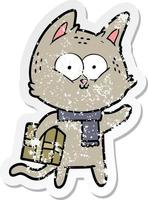 distressed sticker of a cartoon cat holding christmas present vector