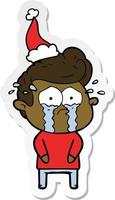 sticker cartoon of a crying man wearing santa hat vector