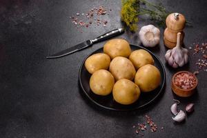 A pile of young potatoes on the table. The benefits of vegetables photo