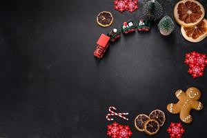 Delicious fresh chocolate biscuits on a dark concrete background with Christmas toys photo