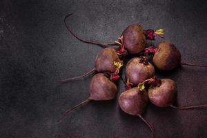 A pile of raw beets on the table. The benefits of vegetables photo