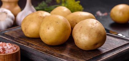 A pile of young potatoes on the table. The benefits of vegetables photo