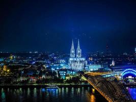 HDR Aerial night view of St Peter Cathedral and Hohenzollern Bri photo