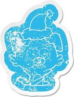 nervous dog cartoon distressed sticker of a wearing santa hat vector