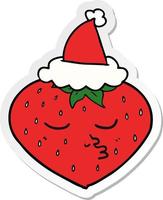 sticker cartoon of a strawberry wearing santa hat vector