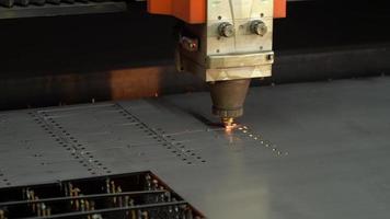 Laser cut, industry. CNC laser cutting machine. The metal sheet is cut on the cnc machine and holes are drilled on it. Laser cutting device following laser light and laser light. video