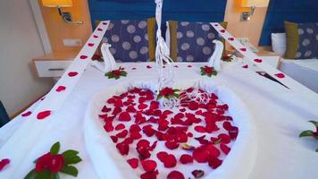 Hotel room concept for honeymoon. Room decorated with rose petals. Red balloons. Romantic hotel room concept. video