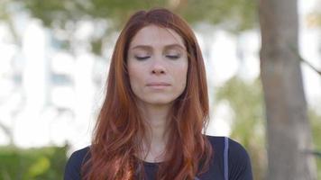 Redhead woman practicing yoga meditation. Woman breathing deeply with eyes closed. Listening to the sound of nature. video