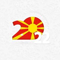 feliz año nuevo 2022 para macedonia sobre fondo de copos de nieve. vector