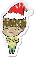 happy distressed sticker cartoon of a boy wearing santa hat vector