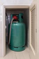 The LPG gas tank for cooking is stored in the small storage compartment. photo